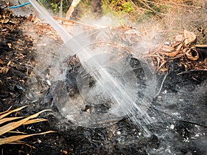 Workers Extinguish Fire with Water