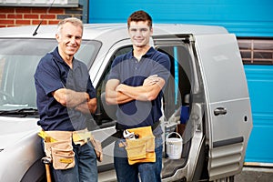 Workers In Family Business Standing Next To Van photo