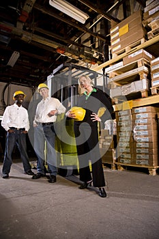 Workers with female boss in storage warehouse