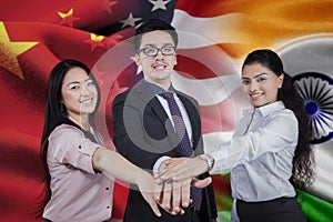 Workers with flag of chinese, american, and indian