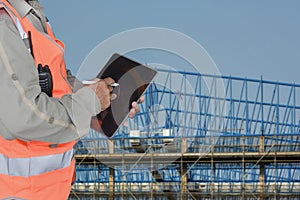 Workers with hand holding tablet, Rear view image of male building worker using digital tablet