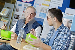 2 workers having lunch together