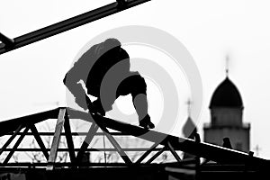 Workers high-builders build a roof