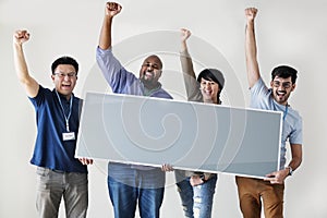 Workers holding blank board together