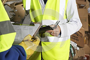 Workers Holding Clipboards In Industry photo