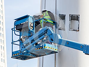 Workers on hydraulic lift
