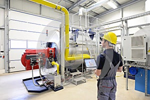 workers in an industrial plant check the systems with modern technology