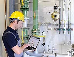 workers in an industrial plant check the systems with modern technology