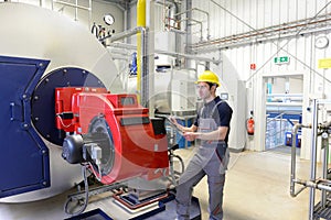 workers in an industrial plant check the systems with modern technology