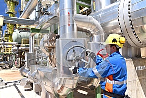 Workers in an industrial plant for the production and processing of crude oil