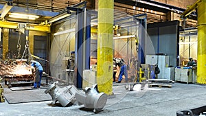 Workers in an industrial plant - workplace foundry - production of steel castings