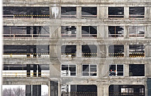 Workers install double-glazed windows in a building under construction