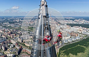 Workers installers at the height work at the top of skyscraper