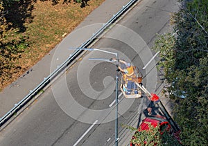 Workers installing a new street lamp
