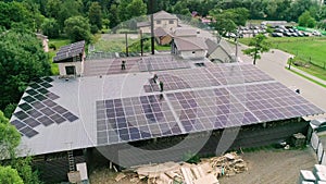 Workers installing PV solar panels on the roof of a house,which converts solar energy into electric energy. Concept of