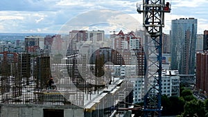 Workers installing reinforcement and formwork. Crane work at construction site