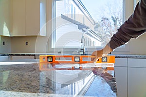 Workers installing top counter kitchen interior cabinet