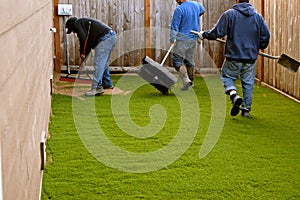 Workers installing turf