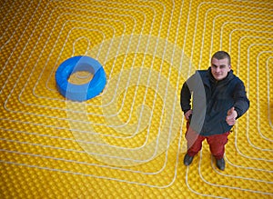 Workers installing underfloor heating system