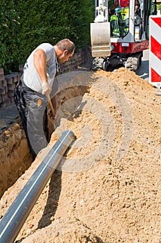 Workers installing underground optical fiber cables