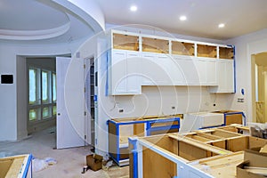 Modern kitchen renovation in progress with cabinetry installation and open layout design