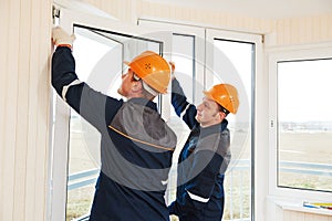 Workers installing window