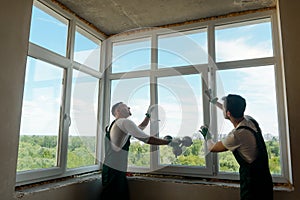Workers are installing a window
