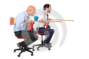 Workers jousting in office chairs
