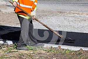 workers lay fresh asphalt on the sidewalk. road industry