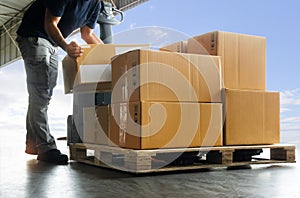 Workers Lifting Packaging Boxes on Pallet. Cardboard Boxes. Shipping Supplies Warehouse. Shipment Boxes. Storehouse.