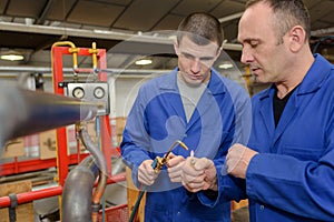 Workers lighting gas torch