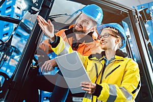 Workers in logistics warehouse checking the inventory