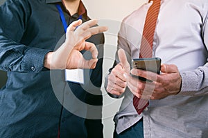 Workers look at the phone and show ok