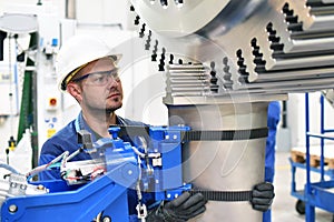 Workers manufacturing steam turbines in an industrial factory