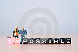Workers men miniature figures use equipment dig to separate wording for change impossible to possible, mindset concept