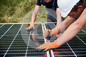 Workers mounting photovoltaic solar panel system