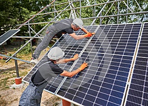 Workers mounting photovoltaic solar panel system