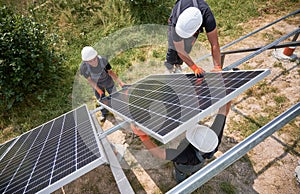 Workers mounting photovoltaic solar panel system