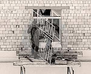 Workers mounting the window  grating