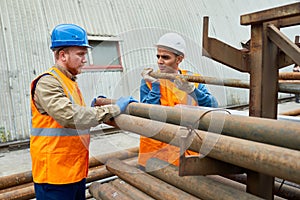 Workers Moving Pipes