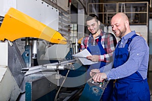 Workers near milling machine