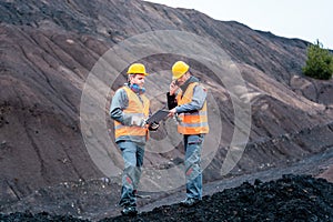 Workers in open-cast mining operation pit photo