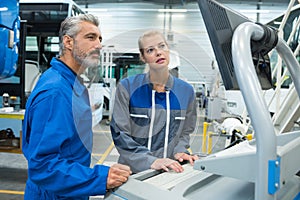 workers operating machine in factory