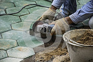 Workers is paving brick floors.