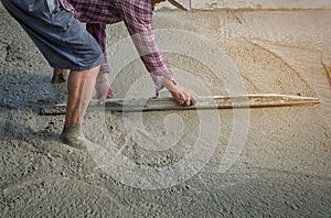 Workers person not wearing dirt boots digging with hoe shovel