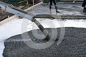 Workers pour the Foundation for the construction of a residential building using mobile concrete mixers.