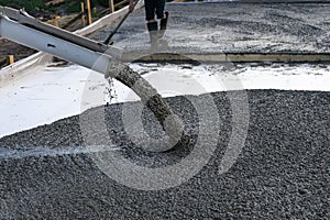 Workers pour the Foundation for the construction of a residential building using mobile concrete mixers.