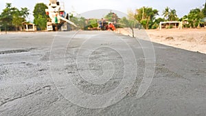 Workers pouring reinforced concrete floors on site