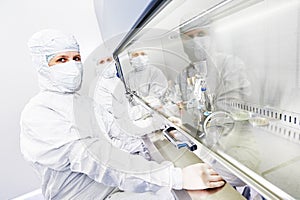 Workers in protective uniform at laboratory