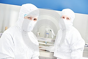 Workers in protective uniform at laboratory